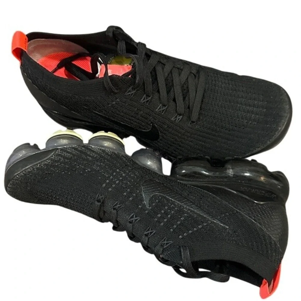 black Nike Air VaporMax Flyknit 3 sneakers with bright crimson/orange accents